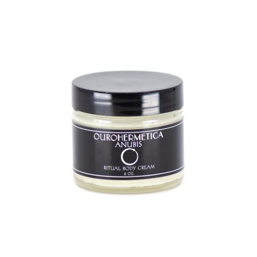 Jar of OuroHermetica Anubis skin cream in clear glass jar with black label with white ouroboros on label