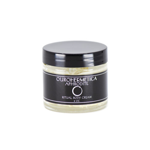 Jar of OuroHermetica Aphrodite skin cream in clear glass jar with black label with white ouroboros on label