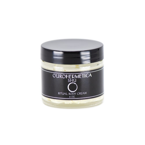 Jar of OuroHermetica Shu skin cream in clear glass jar with black label with white ouroboros