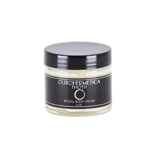 Jar of OuroHermetica Thoth skin cream in clear glass jar with black label with white ouroboros